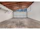 The spacious garage features an open-beam ceiling, lighting, and a garage door with windows at 3013 W Port Au Prince Ln, Phoenix, AZ 85053