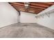 The garage features an open ceiling with exposed beams, as well as shelving and lighting at 3013 W Port Au Prince Ln, Phoenix, AZ 85053