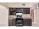 Kitchen featuring tile flooring, ample cabinet space, and black appliances at 3013 W Port Au Prince Ln, Phoenix, AZ 85053