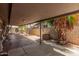 The covered patio features a brick fire pit, ample space, and an adjacent fence at 3013 W Port Au Prince Ln, Phoenix, AZ 85053