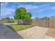 Backyard showcasing a lush lawn, mature tree, access gate, and pool view at 3021 S Evergreen Rd, Tempe, AZ 85282