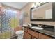 Bathroom featuring a single sink vanity with granite countertop and tub shower at 3021 S Evergreen Rd, Tempe, AZ 85282