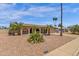 Charming home featuring arched entryway, mature palm trees, and low-maintenance desert landscaping at 3021 S Evergreen Rd, Tempe, AZ 85282