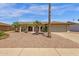 Attractive home with desert landscaping, mature palm trees, and a convenient two-car garage at 3021 S Evergreen Rd, Tempe, AZ 85282