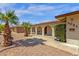 Inviting home featuring a charming, covered entry way, desert landscaping, and well-kept bushes at 3021 S Evergreen Rd, Tempe, AZ 85282