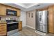 A well-equipped kitchen featuring stainless steel appliances and ample wood cabinet storage at 3021 S Evergreen Rd, Tempe, AZ 85282
