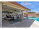 Covered patio with a ceiling fan, dining table, and view of the pool at 3021 S Evergreen Rd, Tempe, AZ 85282