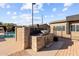 Backyard with outdoor grill and entertaining space near a sparkling pool under a sunny blue sky at 3233 N 37Th St # 5, Phoenix, AZ 85018