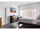 Bright bedroom with a modern dark dresser, a flatscreen TV, and a large window at 3233 N 37Th St # 5, Phoenix, AZ 85018
