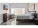 Cozy bedroom featuring a plush bed, a window with blinds, a TV, and a dresser at 3233 N 37Th St # 5, Phoenix, AZ 85018