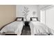 Bright bedroom featuring two twin beds and artistic wall decor, illuminated by natural light at 3233 N 37Th St # 5, Phoenix, AZ 85018