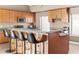 Spacious kitchen island with bar seating and granite countertops, complemented by ample cabinet space at 3233 N 37Th St # 5, Phoenix, AZ 85018