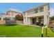 Lush backyard offers artificial grass, patio seating, and a play area with a trampoline at 3308 E Jasper Dr, Gilbert, AZ 85296