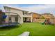 Backyard featuring a well-maintained artificial grass lawn with a trampoline and playground equipment at 3308 E Jasper Dr, Gilbert, AZ 85296