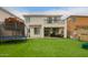 Backyard showcasing artificial grass, outdoor seating, a patio, and second story balcony at 3308 E Jasper Dr, Gilbert, AZ 85296