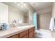 Well-lit bathroom with a large mirror, tiled countertop, and a shower-tub combo at 3308 E Jasper Dr, Gilbert, AZ 85296