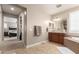 Bathroom featuring double sinks, tile flooring, with view to bedroom and walk-in closet at 3308 E Jasper Dr, Gilbert, AZ 85296