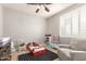 Playful bedroom with a car bed, toy furniture, gray armchair, and white shuttered windows at 3308 E Jasper Dr, Gilbert, AZ 85296