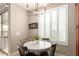 Cozy breakfast nook with round table, modern chandelier, and bright windows for natural light at 3308 E Jasper Dr, Gilbert, AZ 85296