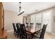 Elegant dining room featuring a dark wood table and seating for eight beneath a decorative chandelier at 3308 E Jasper Dr, Gilbert, AZ 85296