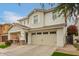 Charming two-story home featuring a covered porch, a two car garage and a landscaped front yard at 3308 E Jasper Dr, Gilbert, AZ 85296
