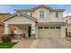 Charming two-story home featuring a covered porch, a two car garage and a landscaped front yard at 3308 E Jasper Dr, Gilbert, AZ 85296