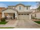 Charming two-story home featuring a covered porch, a two car garage and a landscaped front yard at 3308 E Jasper Dr, Gilbert, AZ 85296