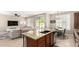 Open concept kitchen with island, breakfast nook, and living room create ideal entertaining space at 3308 E Jasper Dr, Gilbert, AZ 85296