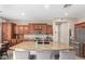 Spacious kitchen island with granite countertops, bar seating, and stainless steel appliances at 3308 E Jasper Dr, Gilbert, AZ 85296