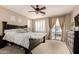 Inviting main bedroom with ceiling fan, balcony access, and a large comfortable bed at 3308 E Jasper Dr, Gilbert, AZ 85296