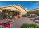 Entertain outdoors on this spacious patio with a fire pit, lounge furniture, and serene landscaping at 343 W Twin Peaks Pkwy, San Tan Valley, AZ 85143