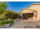 Gorgeous outdoor living space featuring a fire pit, seating, and mature landscaping at 343 W Twin Peaks Pkwy, San Tan Valley, AZ 85143