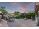 Relaxing backyard with lounge chairs, fire pit, and mature landscaping, creating a serene outdoor retreat at 343 W Twin Peaks Pkwy, San Tan Valley, AZ 85143