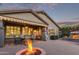 Backyard featuring a covered patio, outdoor seating, a fire pit, and a stone fireplace at 343 W Twin Peaks Pkwy, San Tan Valley, AZ 85143