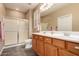 Bathroom featuring a double vanity with two sinks, tile floors, and a walk-in shower at 343 W Twin Peaks Pkwy, San Tan Valley, AZ 85143