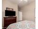 Bedroom featuring wood-look floors, ceiling fan, and a dresser with a TV on top at 343 W Twin Peaks Pkwy, San Tan Valley, AZ 85143