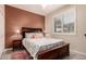 Bedroom with wood-look floors, a ceiling fan, and a large window with plantation shutters at 343 W Twin Peaks Pkwy, San Tan Valley, AZ 85143