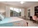 Bedroom featuring wood floors, plantation shutters, and outdoor views at 343 W Twin Peaks Pkwy, San Tan Valley, AZ 85143