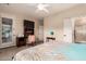 Bedroom featuring wood floors, a ceiling fan, and an ensuite bath with a walk-in shower at 343 W Twin Peaks Pkwy, San Tan Valley, AZ 85143