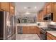 Well-lit kitchen features stainless steel appliances, light countertops, tile floors, and medium wood cabinets at 343 W Twin Peaks Pkwy, San Tan Valley, AZ 85143