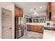 Well-lit kitchen features stainless steel appliances, light countertops, tile floors, and medium wood cabinets at 343 W Twin Peaks Pkwy, San Tan Valley, AZ 85143