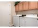 Functional laundry room featuring cabinetry above washer and dryer for ample storage space at 343 W Twin Peaks Pkwy, San Tan Valley, AZ 85143