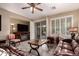 Inviting living room featuring a ceiling fan, tile flooring, and sliding doors to the patio at 343 W Twin Peaks Pkwy, San Tan Valley, AZ 85143