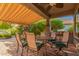 Enjoy an outdoor dining space on the covered patio with a grill and lush greenery at 343 W Twin Peaks Pkwy, San Tan Valley, AZ 85143