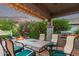 Enjoy outdoor dining on this covered patio with a grill and view of the well-manicured backyard at 343 W Twin Peaks Pkwy, San Tan Valley, AZ 85143
