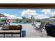Outdoor patio with tan couches and a beautiful view of the backyard swimming pool at 3515 N Brooklyn Dr, Buckeye, AZ 85396
