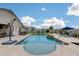 Relaxing backyard pool with waterfall, tanning ledge, and comfortable lounge chairs at 3515 N Brooklyn Dr, Buckeye, AZ 85396