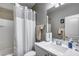 Cozy bathroom with a sink and vanity, toilet, and shower with a curtain at 3515 N Brooklyn Dr, Buckeye, AZ 85396