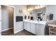 Elegant bathroom featuring a double vanity, large mirrors, and modern lighting at 3515 N Brooklyn Dr, Buckeye, AZ 85396