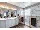 Luxurious bathroom featuring a double vanity, a spacious walk-in shower with marble walls, and sleek finishes at 3515 N Brooklyn Dr, Buckeye, AZ 85396